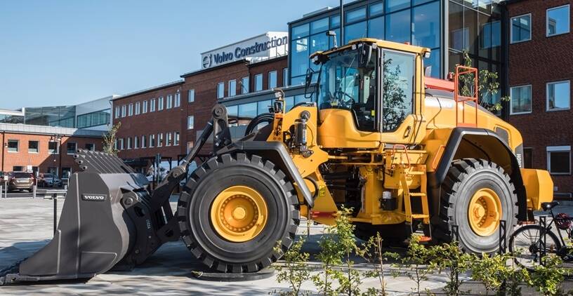Whee loader in front of a Volvo building