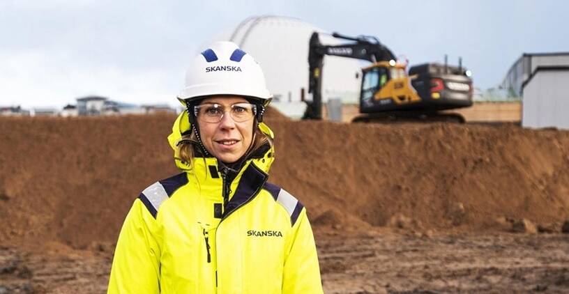 Woman in hardhat at construction site