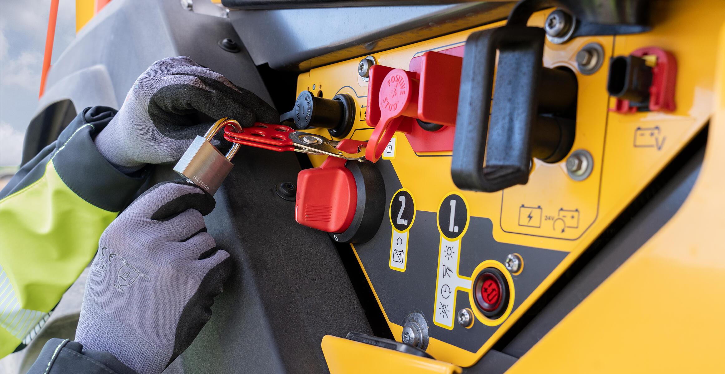 A person holding a lock or a Lock-out-tag-out device (LOTO)