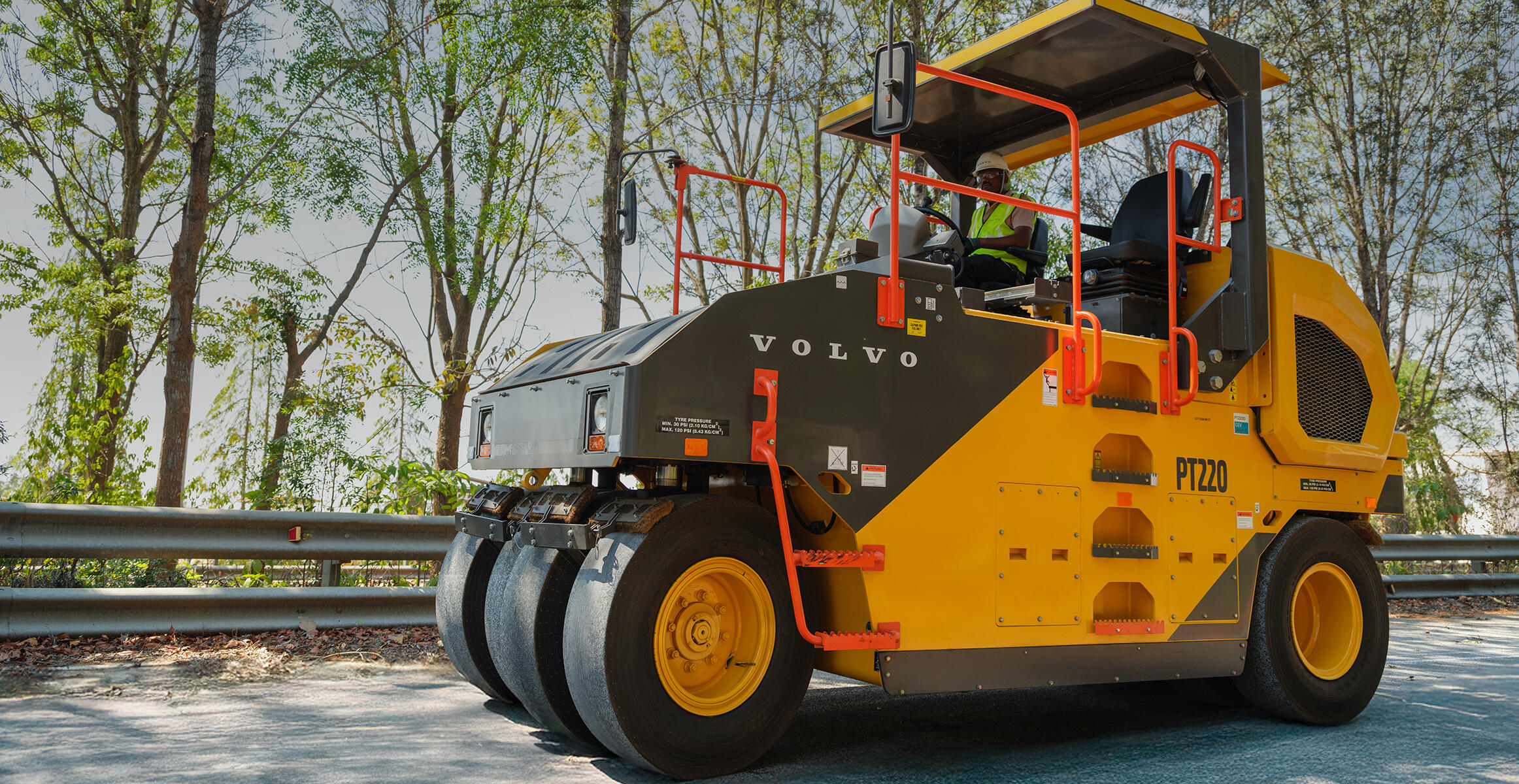 Side view of the PT220 Tyre Roller showing large orange hand rails
