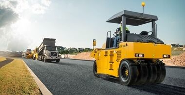 PTR240  asphalt compactors finishing the asphalt surface in front of truck and a paver