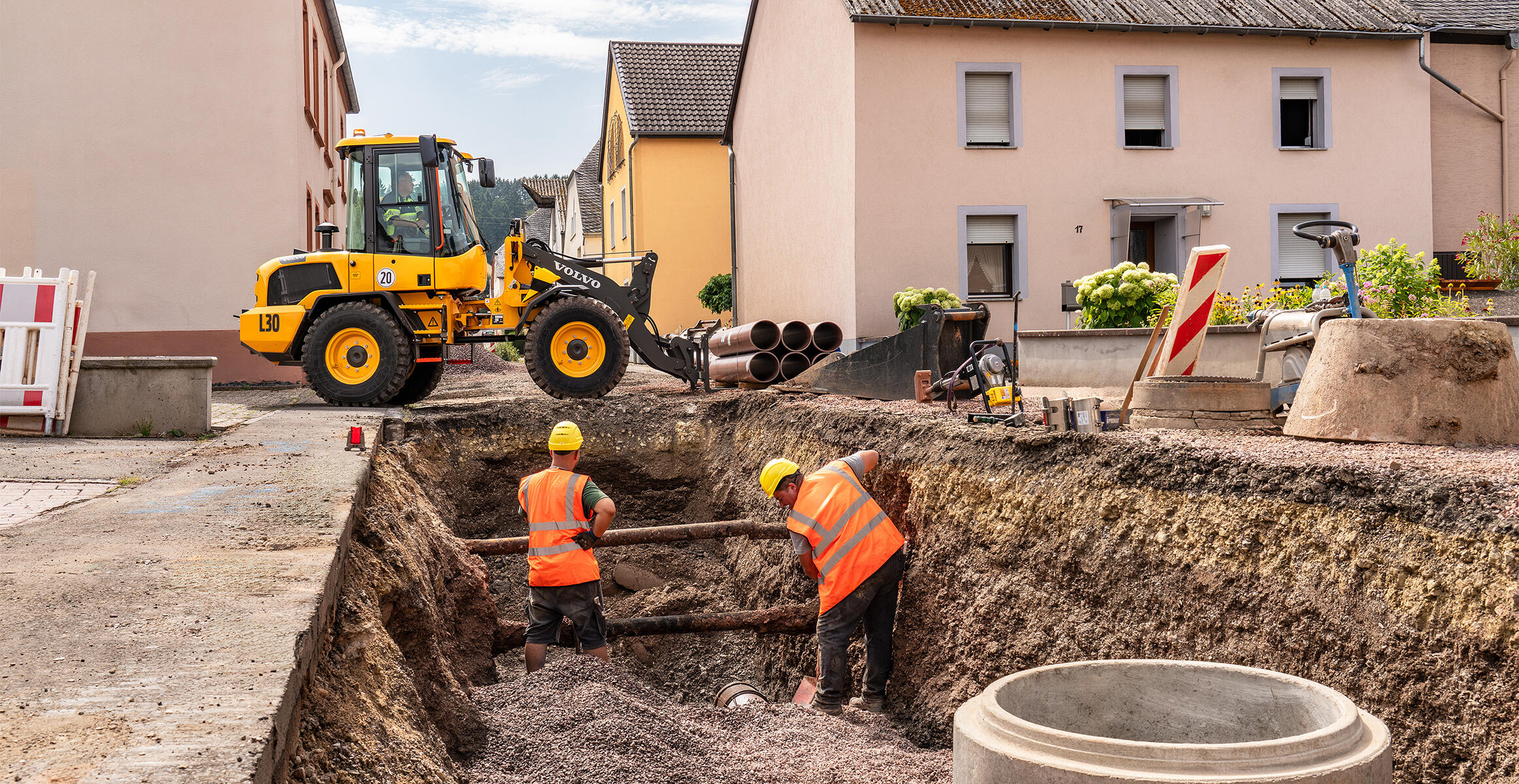 Volvo L30 Compact Wheel Loader working on a confined construction site beside a trench.