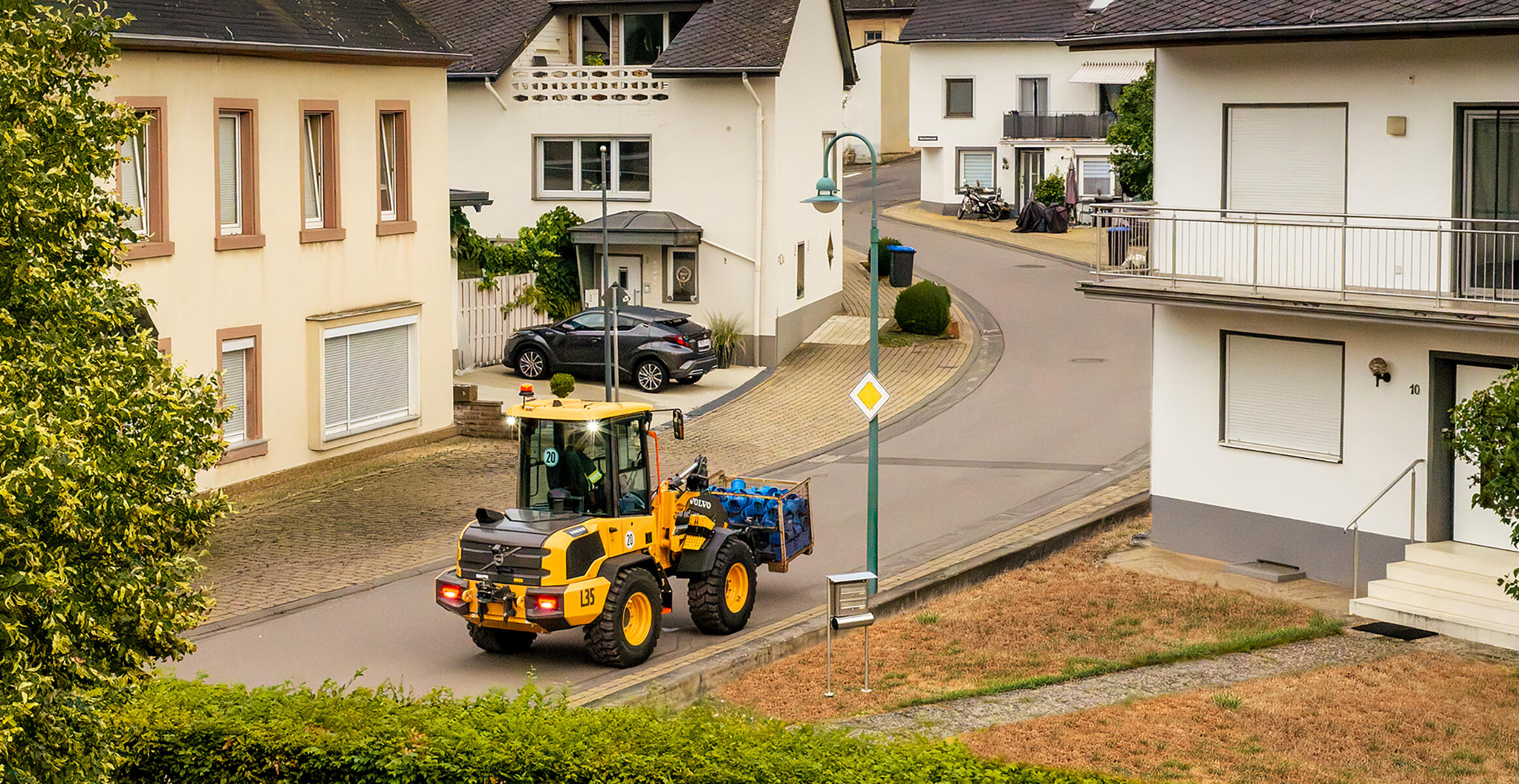 Volvo L35 Compact Wheel Loader working in a confined residential jobsite.