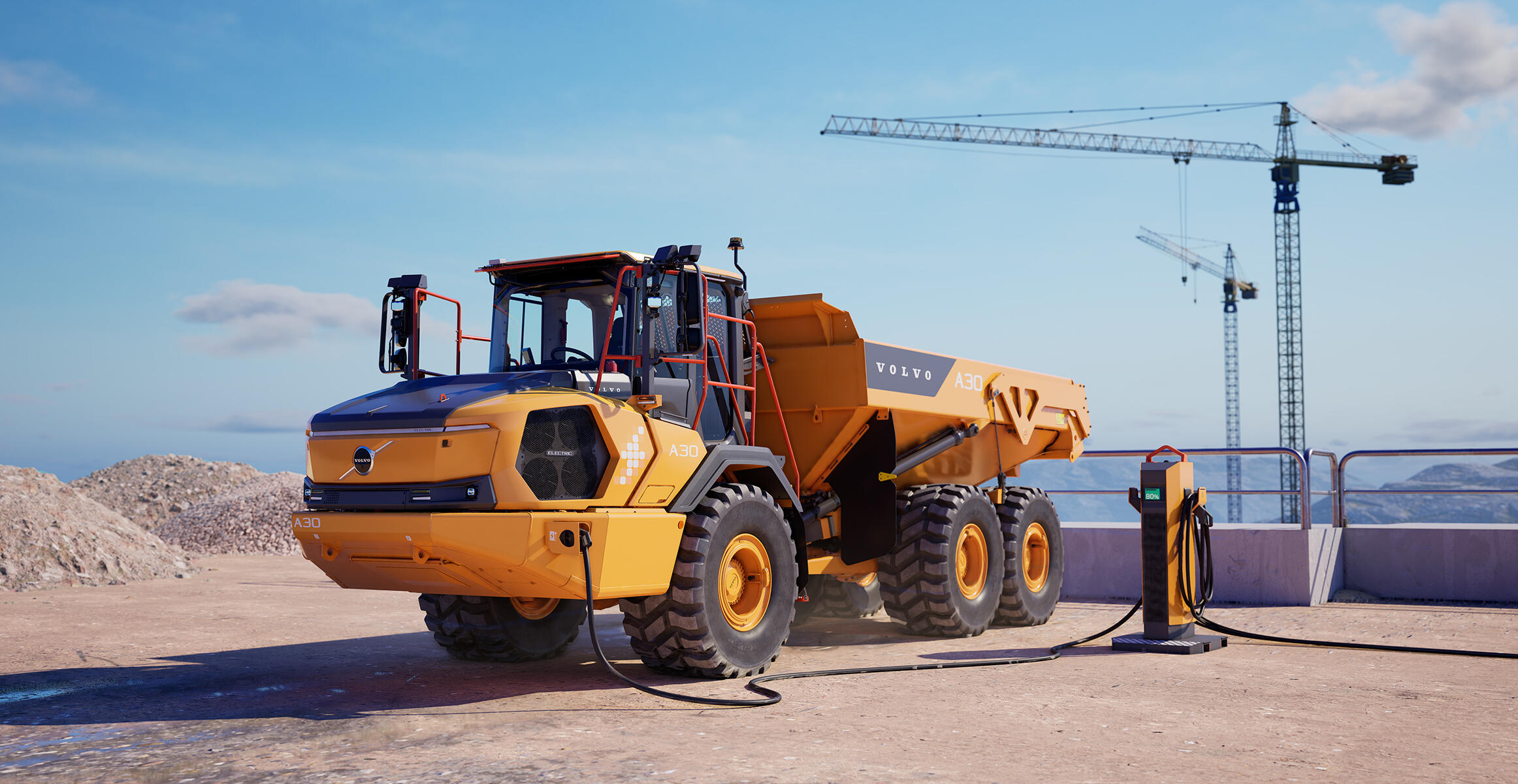 Un tombereau articulé électrique Volvo branché à une station de recharge sur un chantier