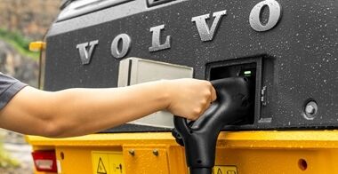 An operator connect in the rear side of the  L120 electric wheel loader into the charging port.