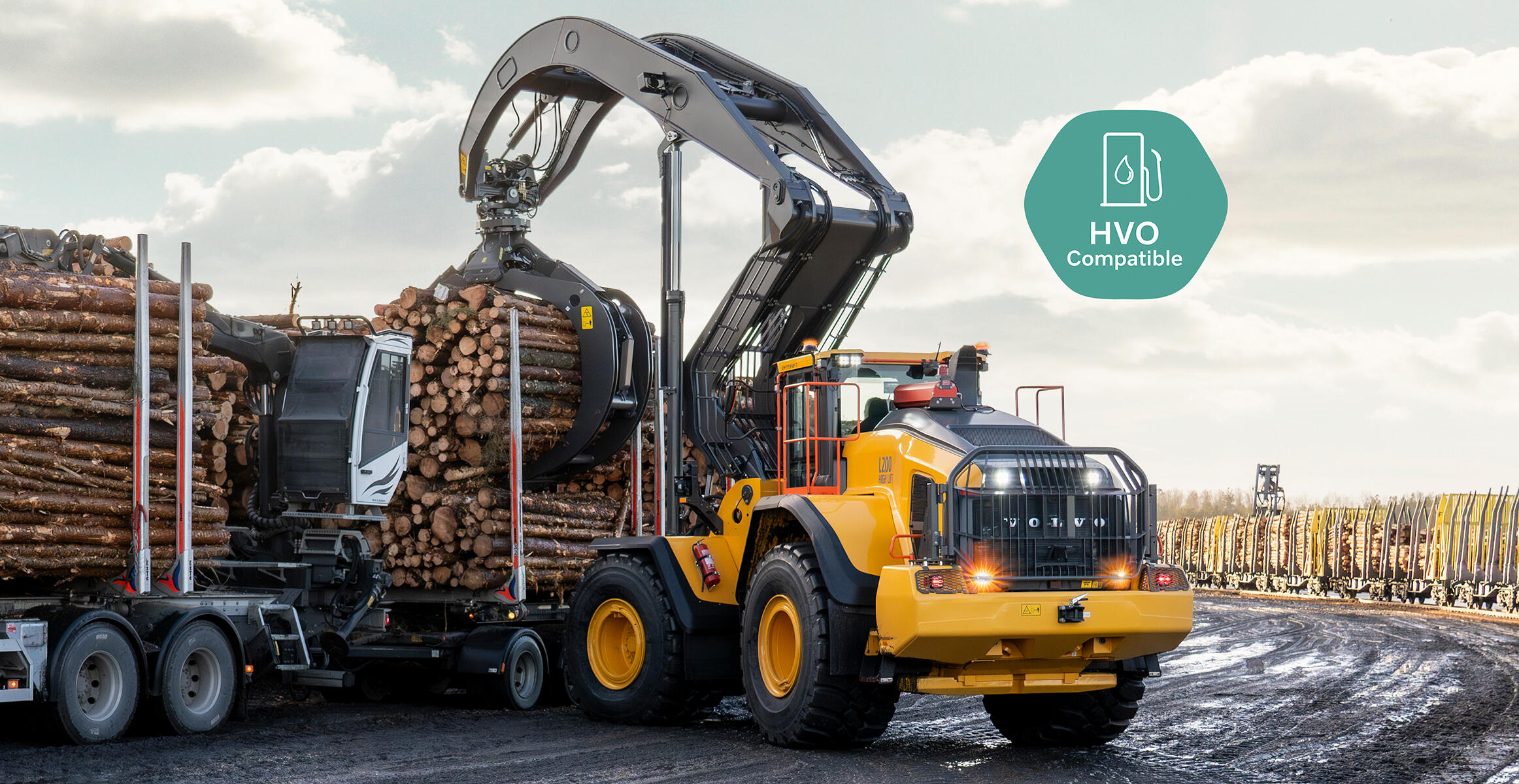 Volvo L200 High Lift wheel loader loading logs onto a truck