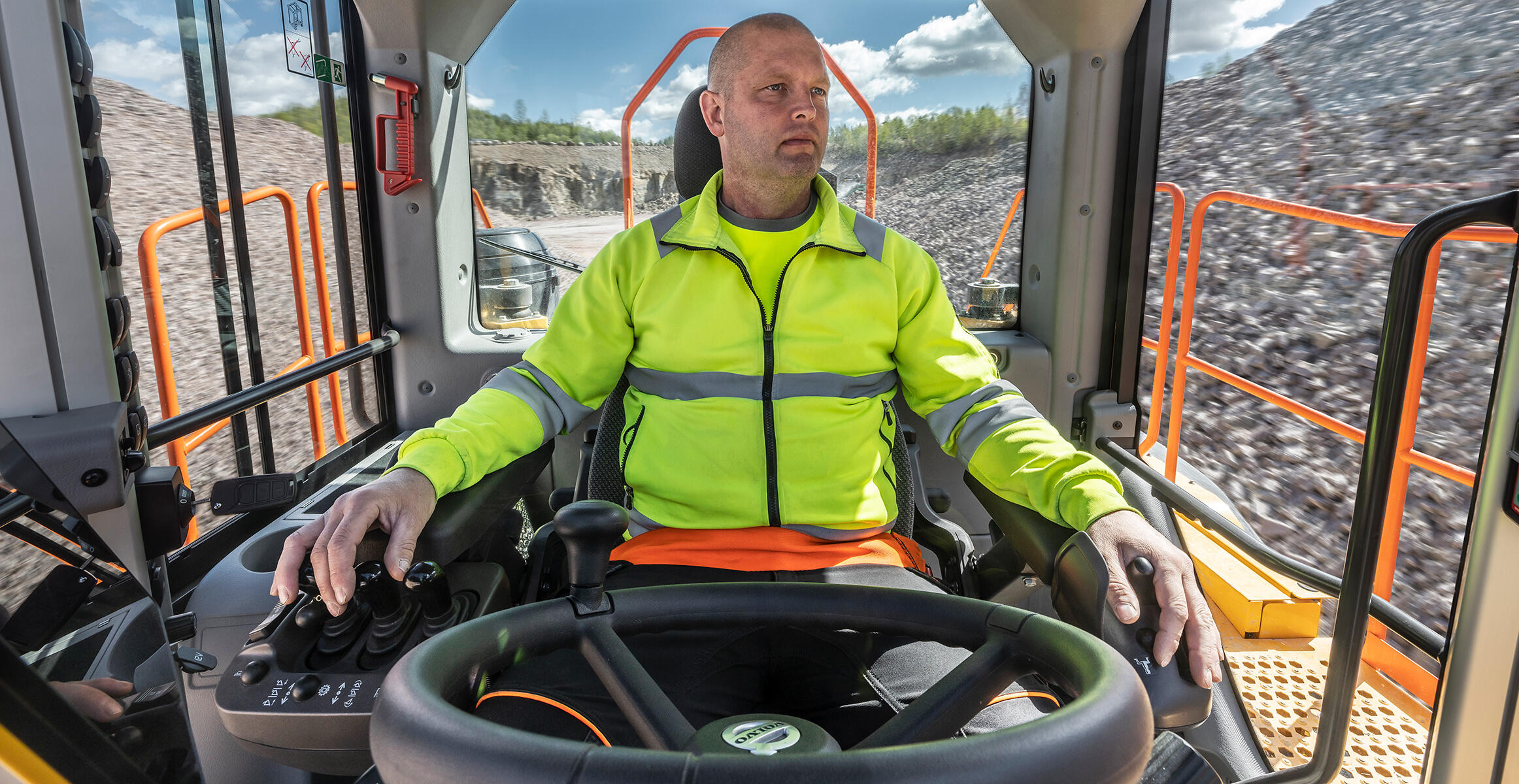 Wide view of the L350H cabin showing the excellent positioning of controls & switches for the operator hands.