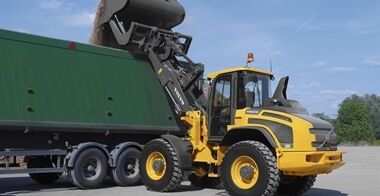 The Volvo L50H performing loading or lifting operations in an industrial environment with Tp-linkage.
