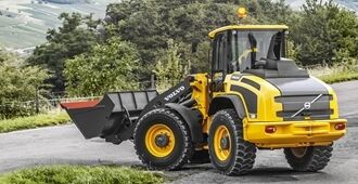 Side profile of the Volvo L50H highlighting its spacious operator cabin and durable tires.