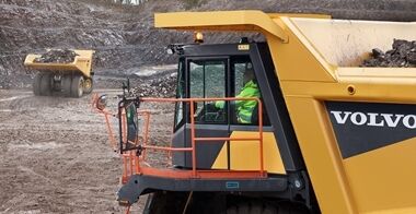 2 Volvo R70 mining trucks loaded with coal materials.