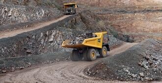 2 Volvo R70 rigid haulers transporting stones to the crusher.