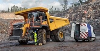 Volvo R70 rigid truck with grouped service points checked by service technician.