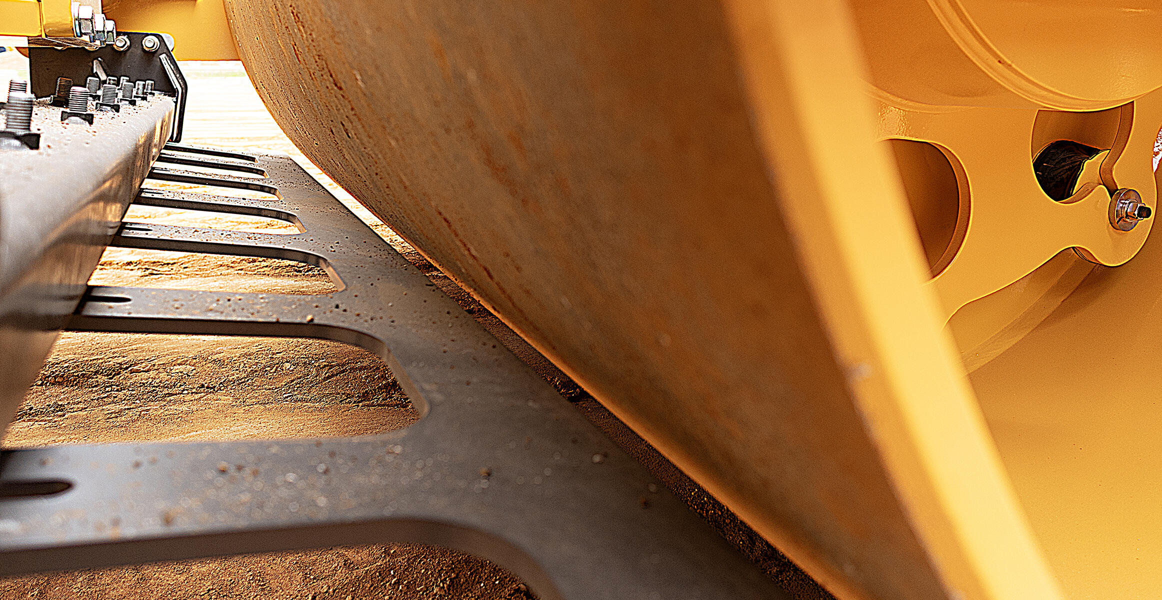 close-up view of the scraper blade that can be installed on an SD120 compactor to maintain drum surface cleanliness by scraping debris