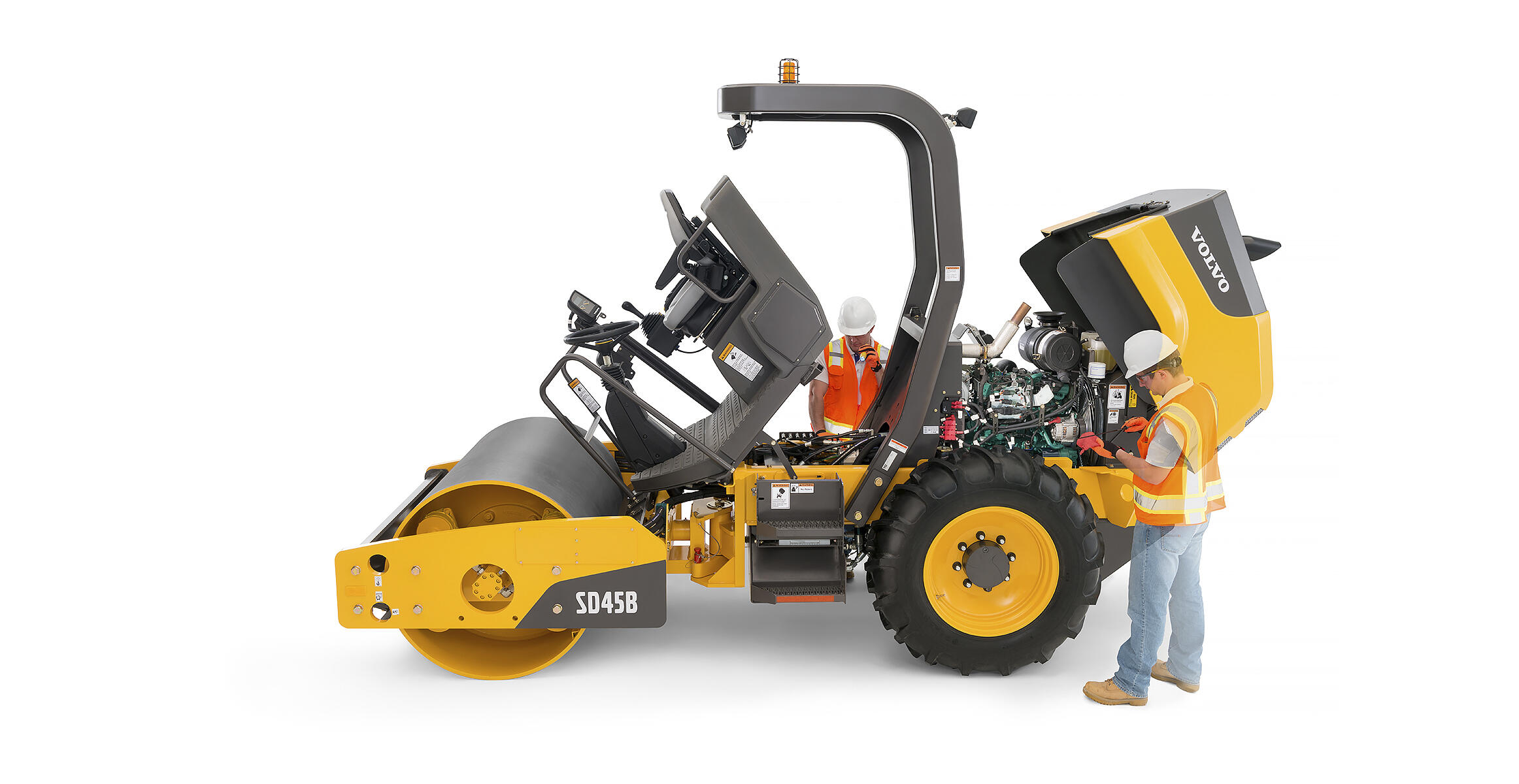 Side view of a SD45B soil compactor during maintenance an operator verifying from ground level service checkpoints