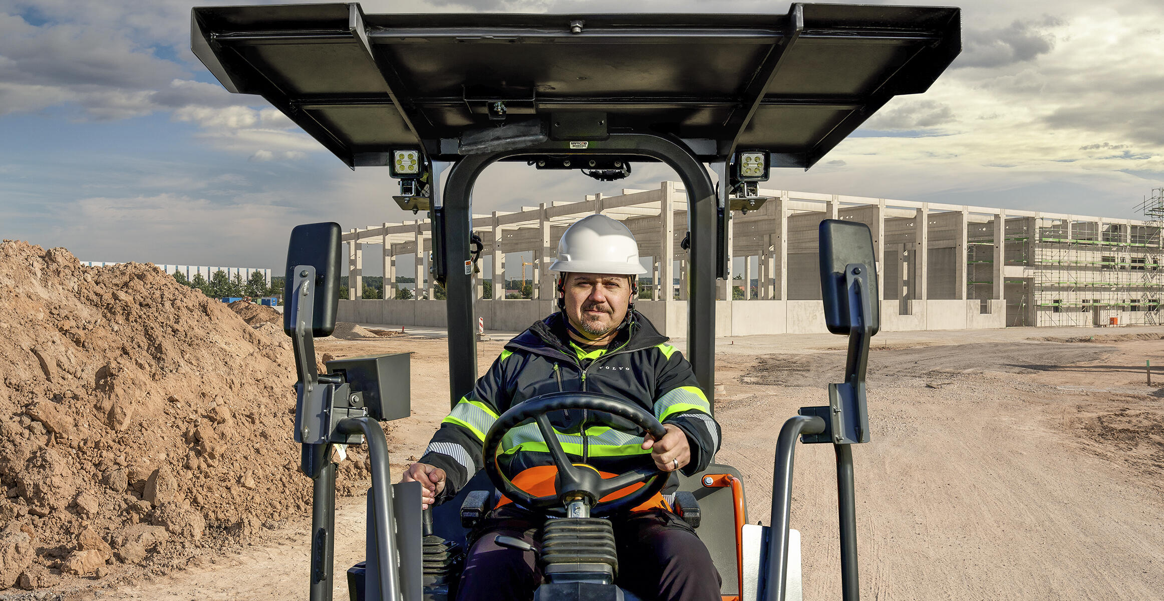 Front view of an operator driving a Volvo SD70 soil compactor