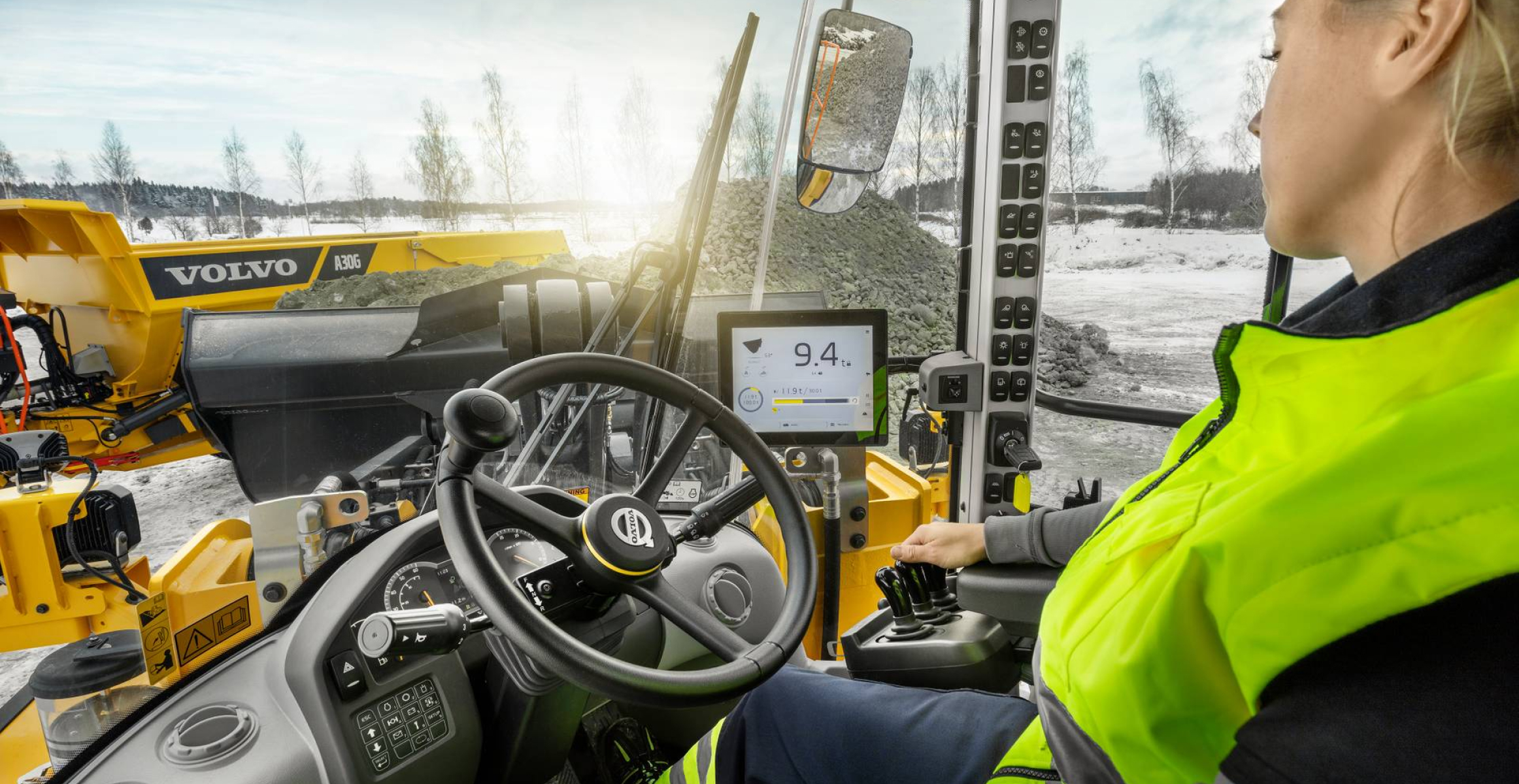 Woman inside the cab, driving a machine