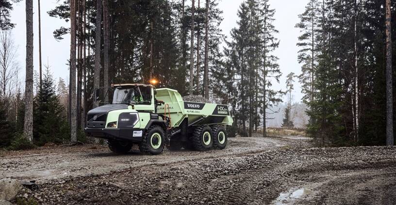 Hydrogen articulated truck driving in forest