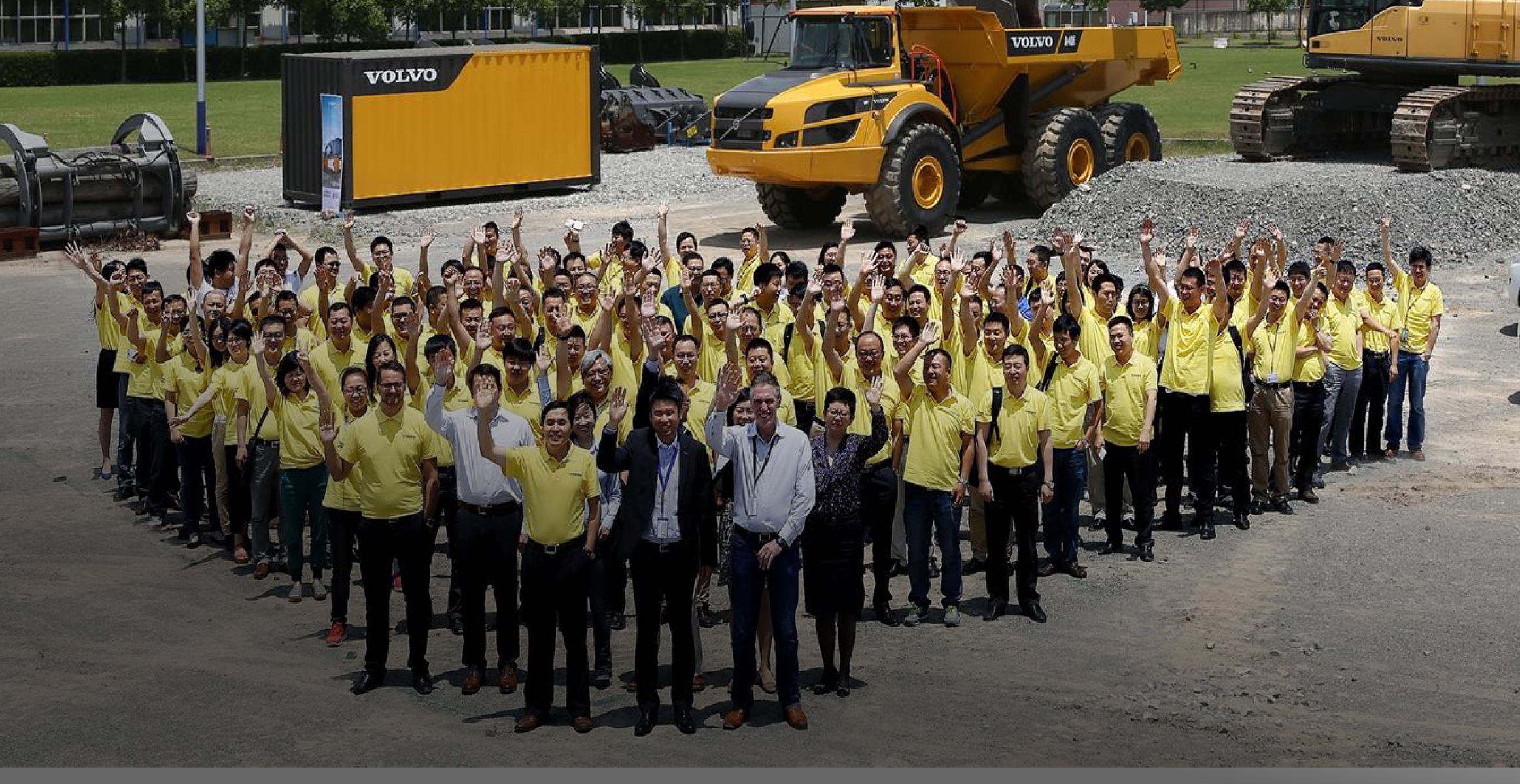Volvo employees waving 