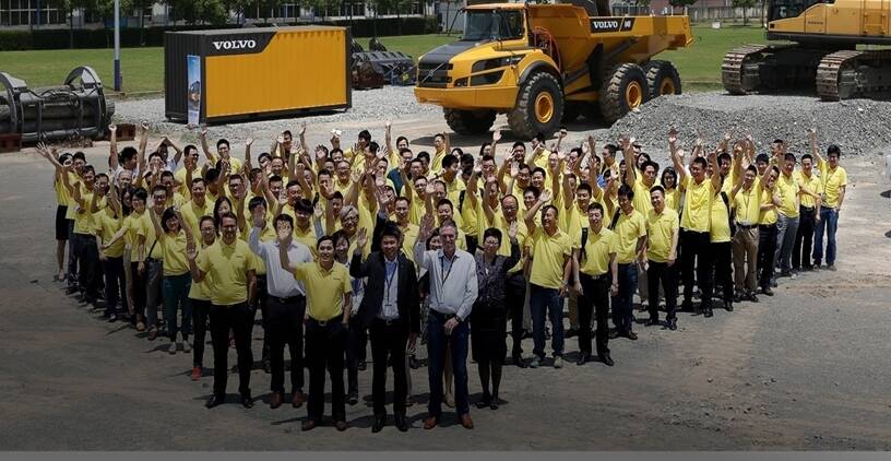 Volvo employees waving 
