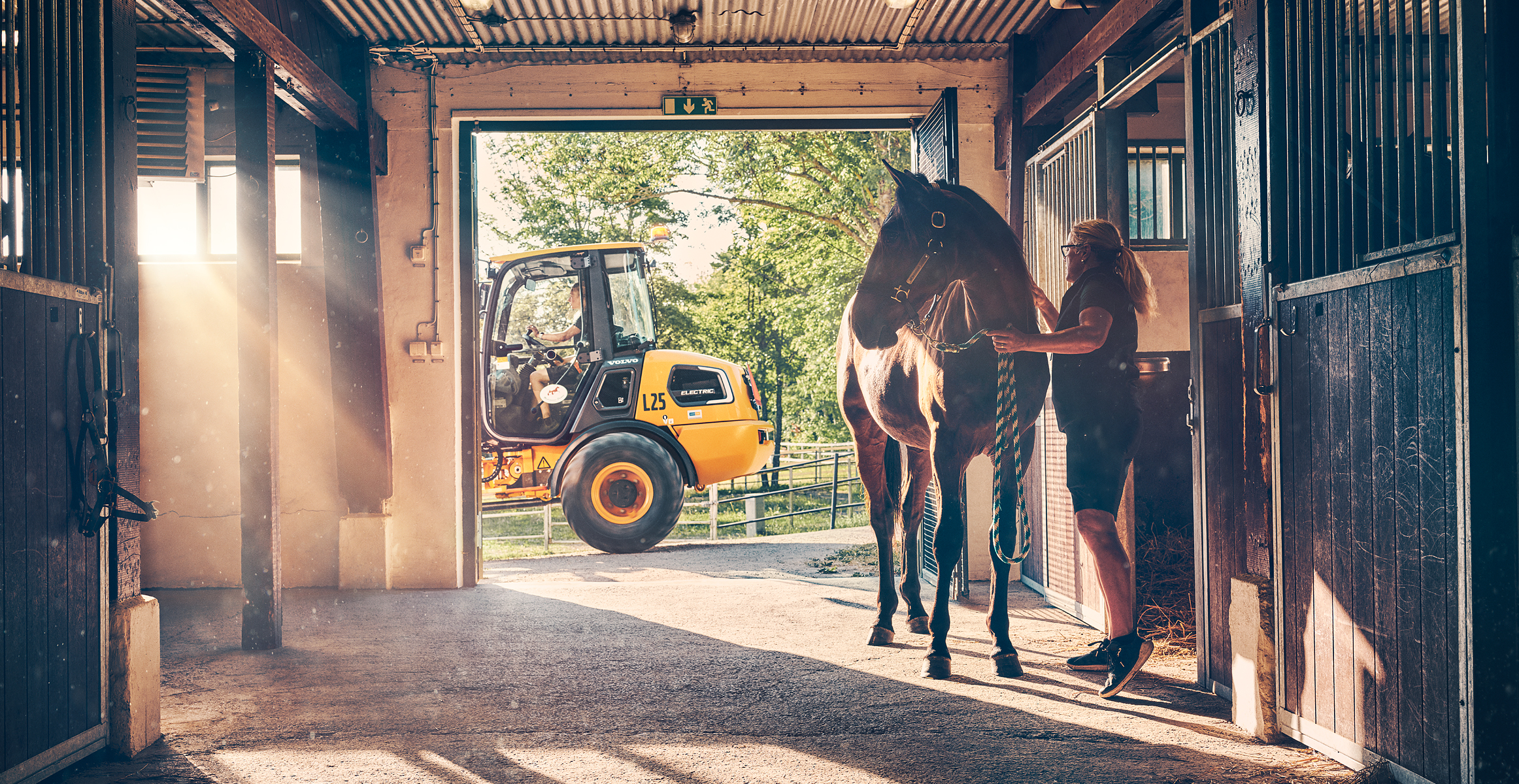 Electric compact wheel loader working within equestrian