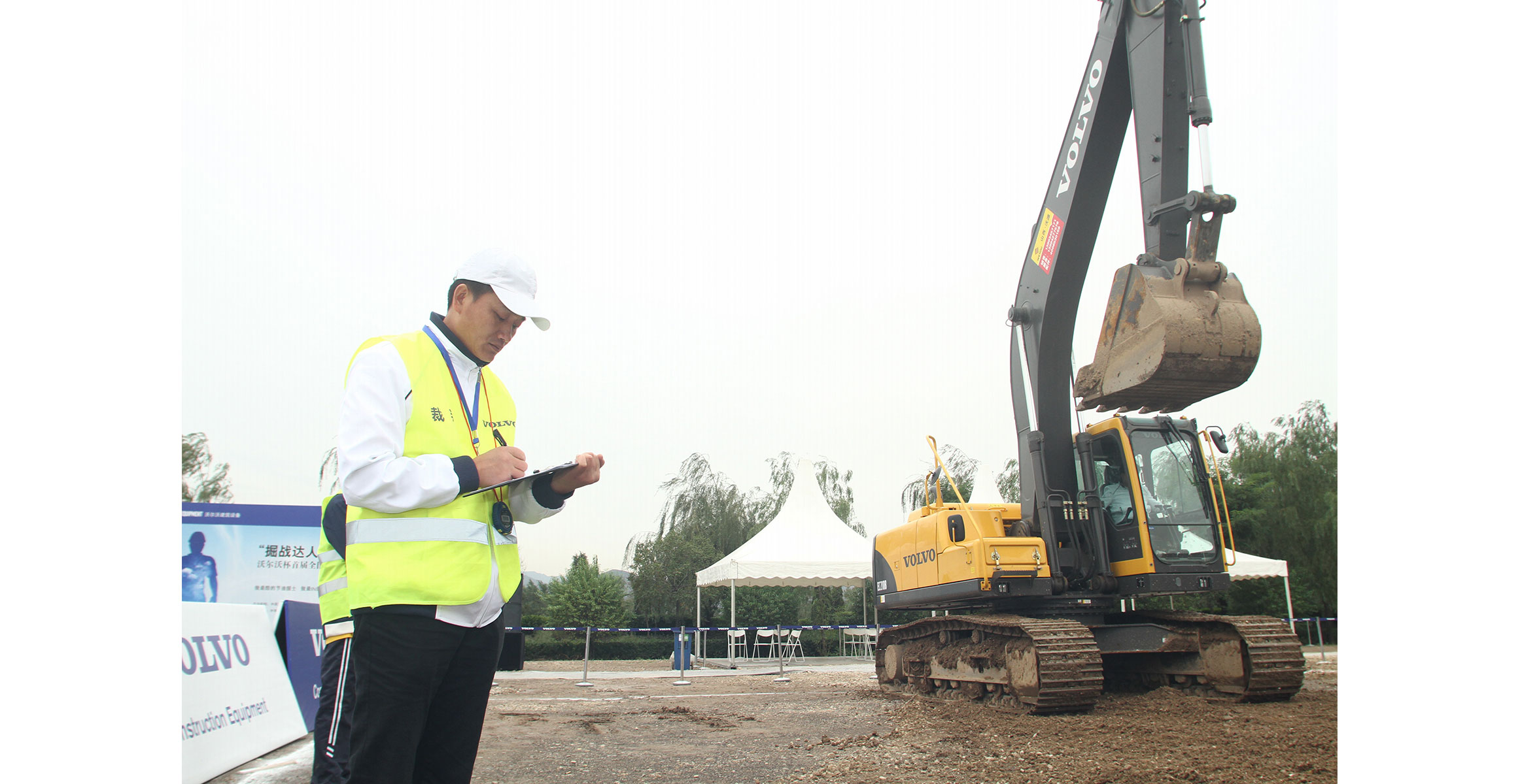A judge observes the operator of a Volvo EC210B crawler excavator during Volvo Construction Equipment’s Operator Idol contest in  China.