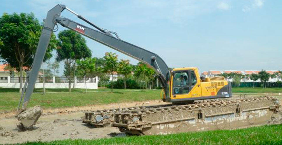 An EC210 excavator in amphibious long boom-and-arm dredging guise.