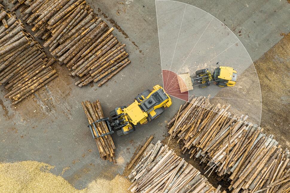 two Volvo machines in a construction yard