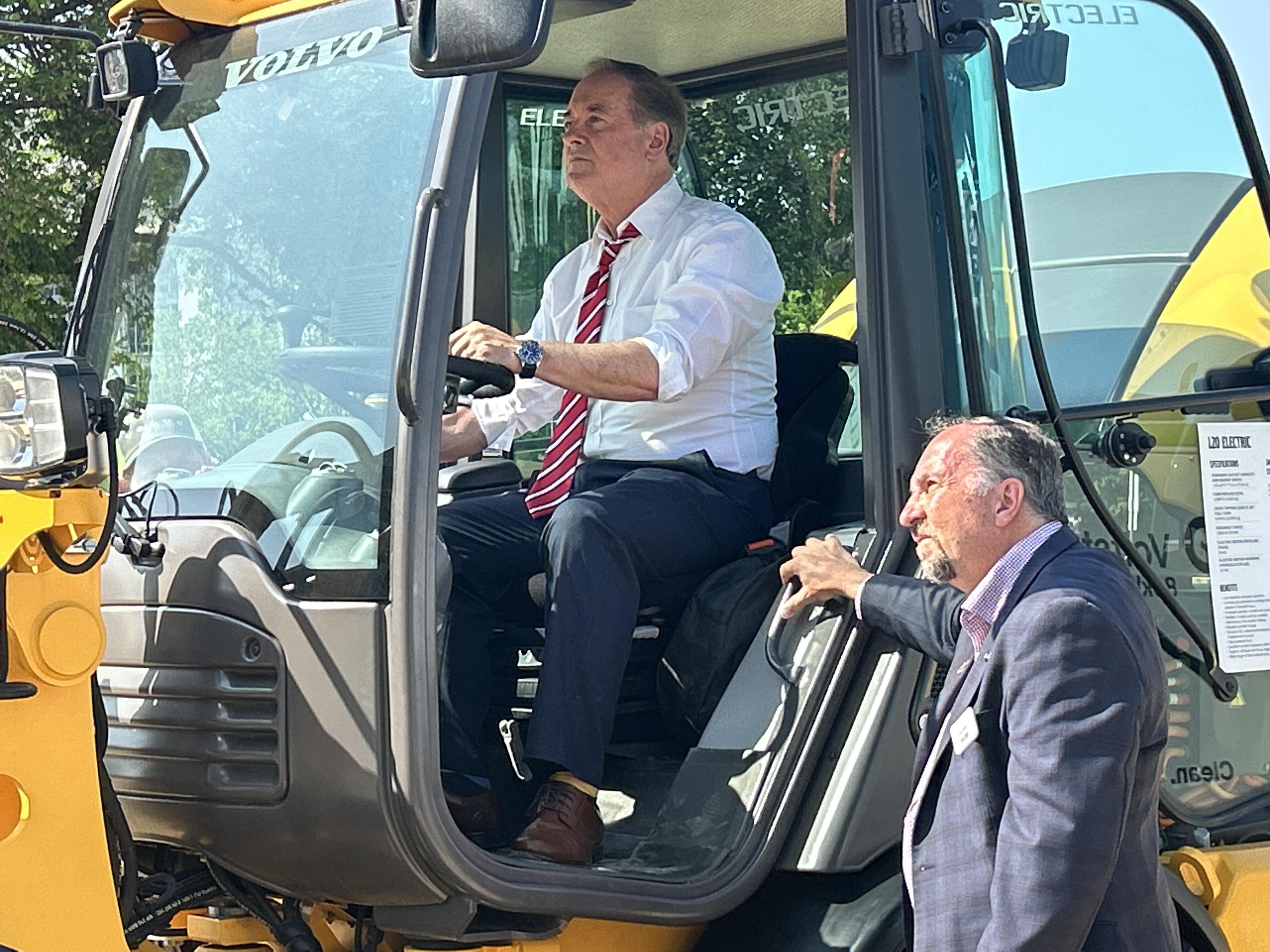 two men testing out a volvo excavator