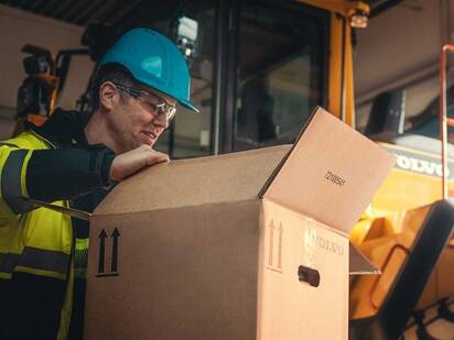 Zadowolony klient Volvo z paczką części zamiennych z Volvo CE Marketplace.