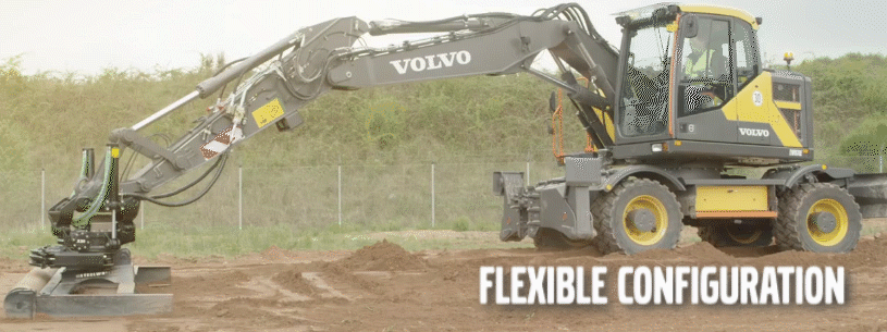 Volvo wheeled excavator moving dirt on a site prep job with a two-piece boom and attachment.