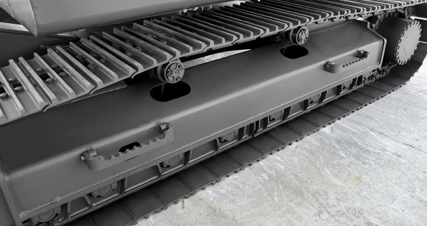 Close-up of a Volvo excavator undercarriage.