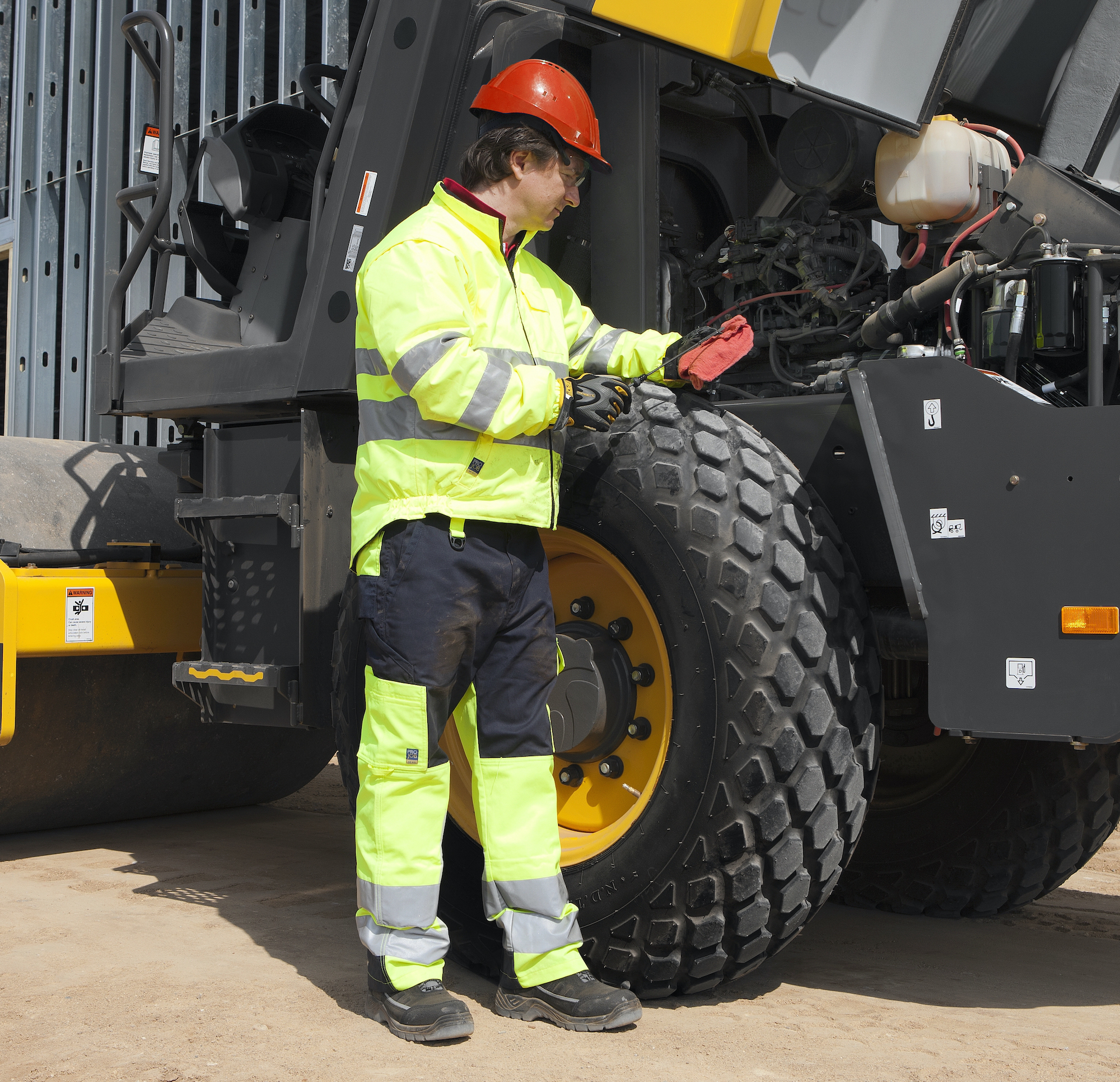 Heavy Equipment Technician Checking Fluid Levels