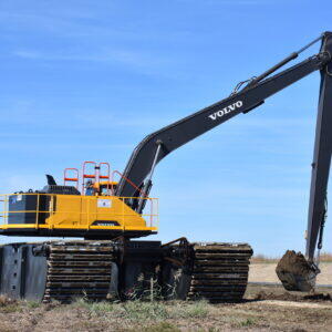 Volvo excavator with a long-reach boom and pontoon tracks.
