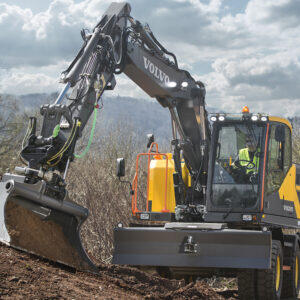 Volvo wheeled excavator finishing dirt work in a remote area.