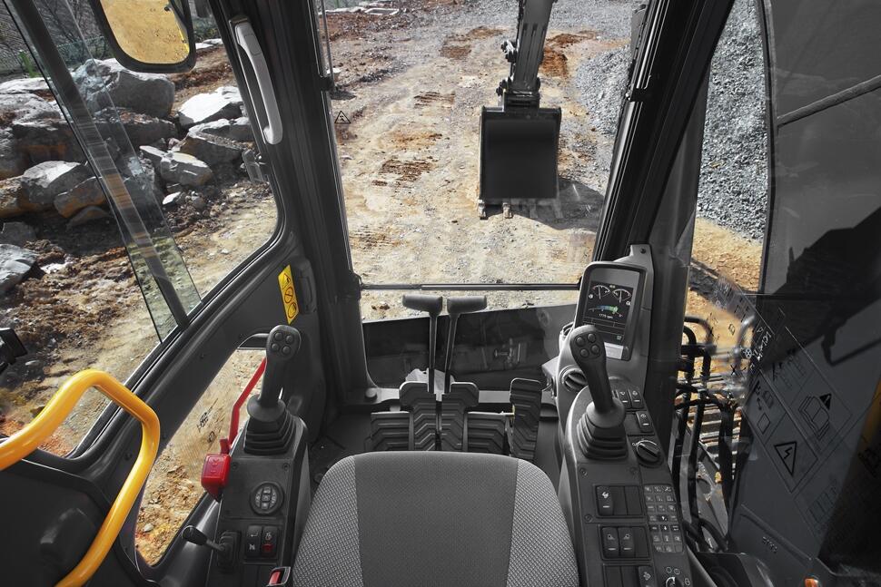 View out the front windows from the cab of an excavator.