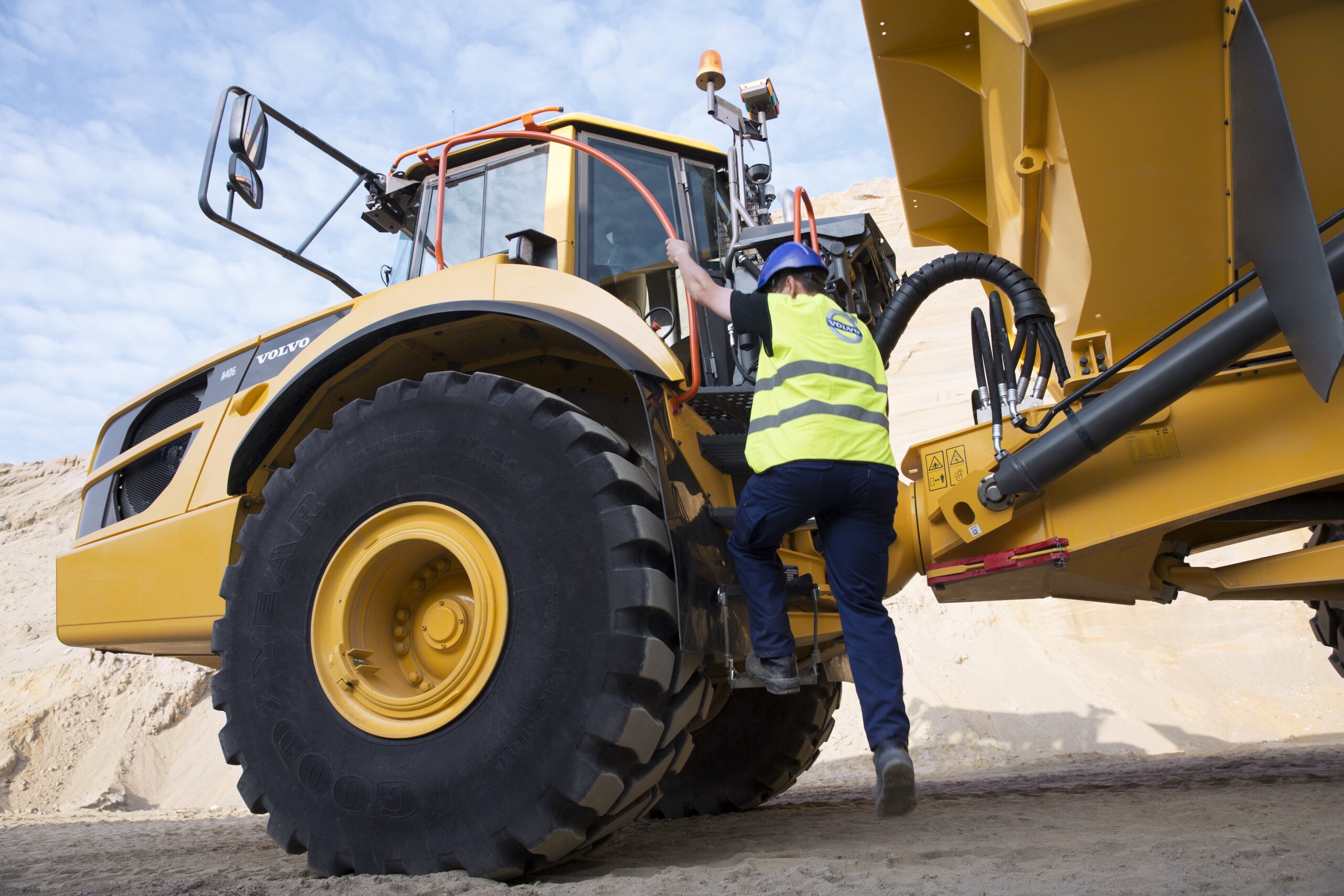 Machine operator safely exiting Volvo machine