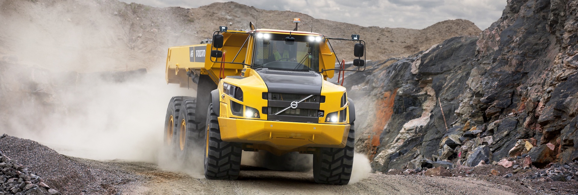 Photo of a Volvo articulated haul truck hauling rock in a quarry