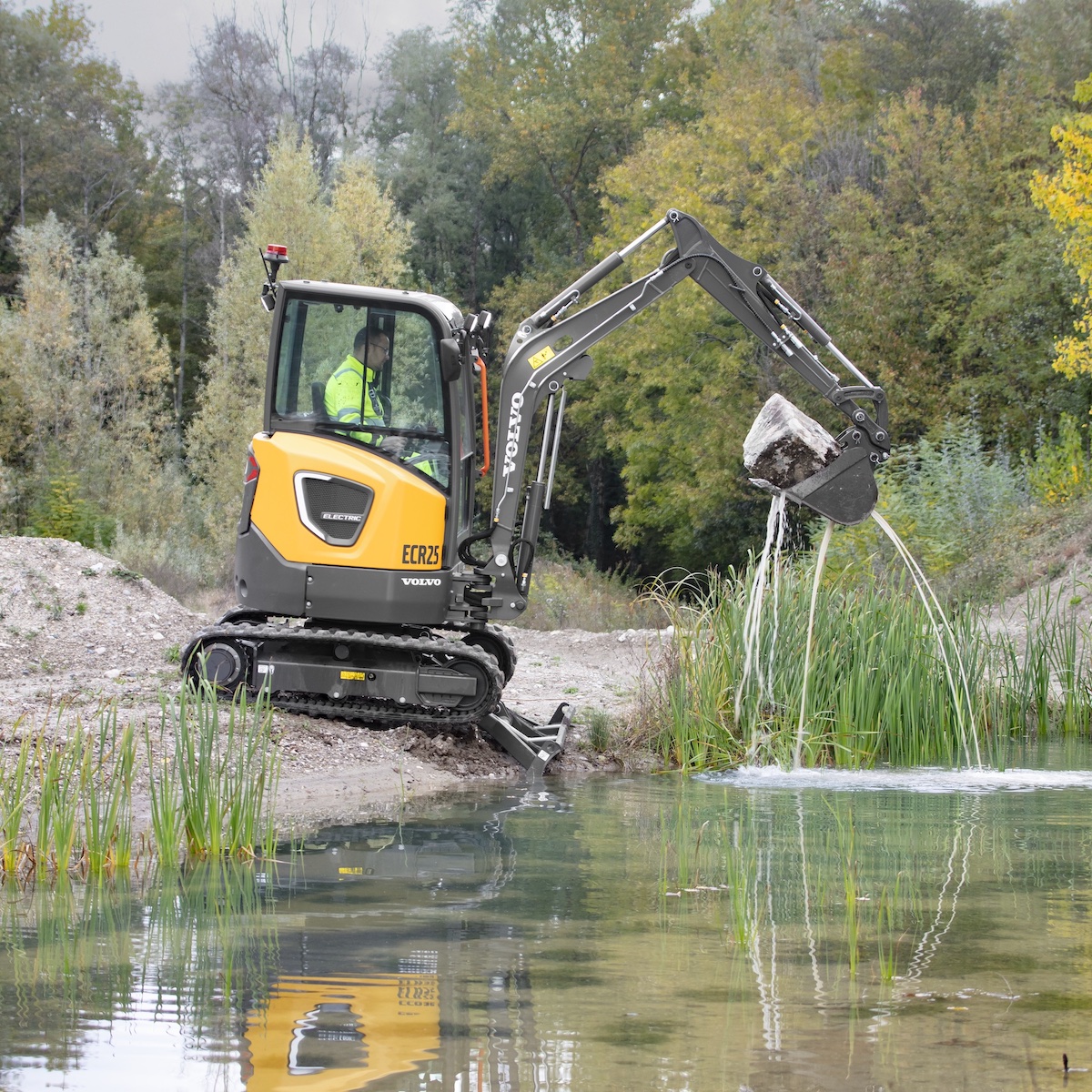 Photo of compact Volvo electric excavator working in landscaping