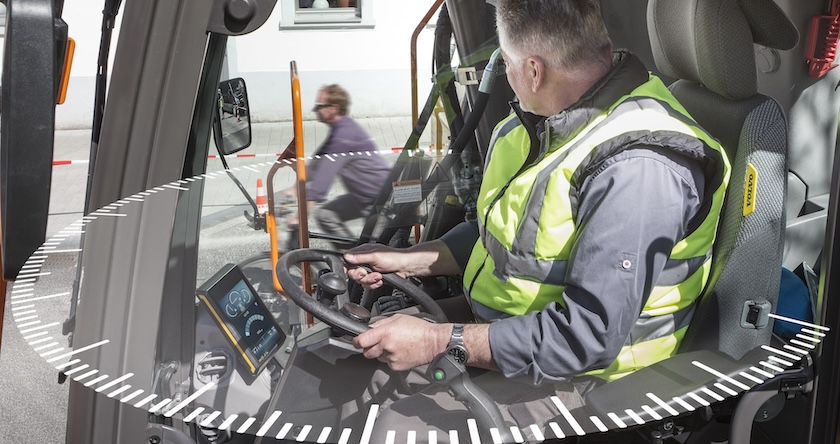 View of a wheeled excavator operator with graphics showing his wide range of view out of the cab.