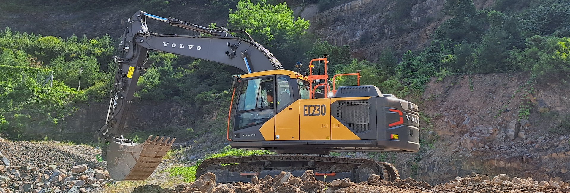New Volvo EC230 excavator moving dirt.