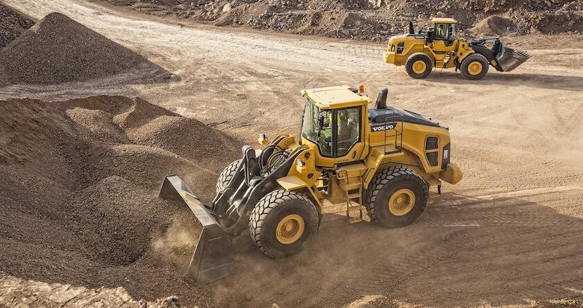 Two Volvo L150H rehandling wheel loaders load and haul aggregate.