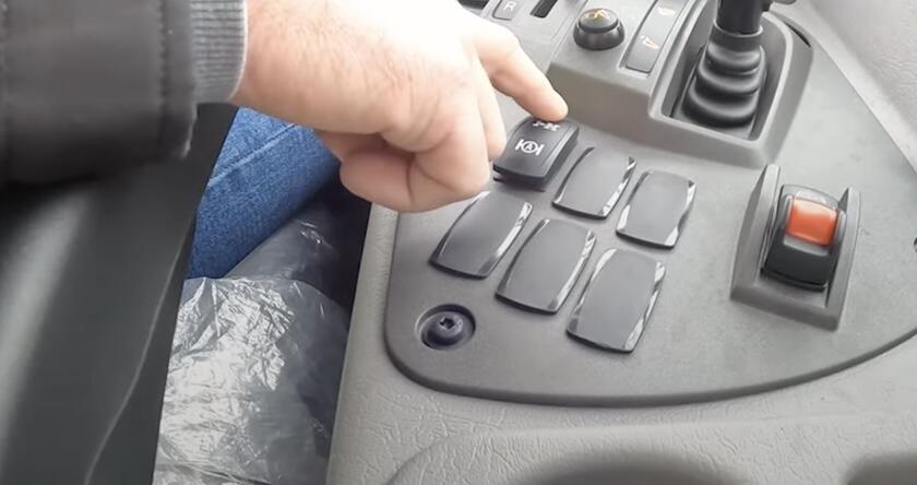Close up of an operator selecting the Automatic Traction Control button in a Volvo articulated hauler.