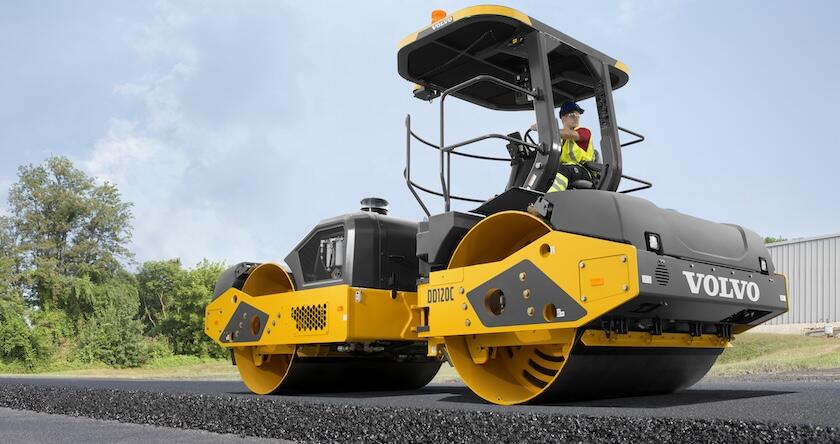 A Volvo DD120C asphalt roller compacting an asphalt mat.