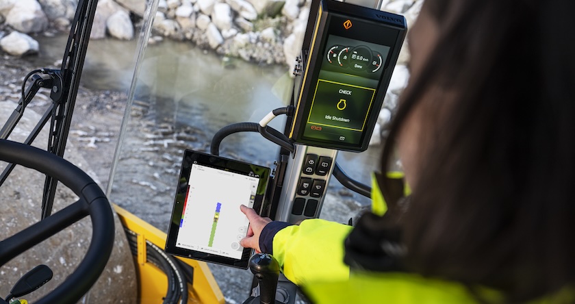 An operator using Volvo Compact Assist for Soil in the cab of a Volvo earth compactor.