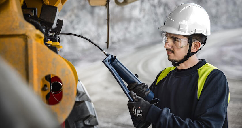 A service tech working on a new Volvo articulated haul truck.