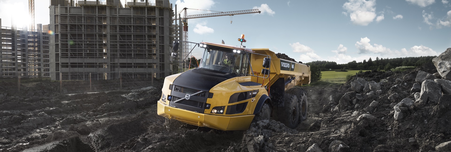 A Volvo A40G articulated truck hauling dirt on a construction site.