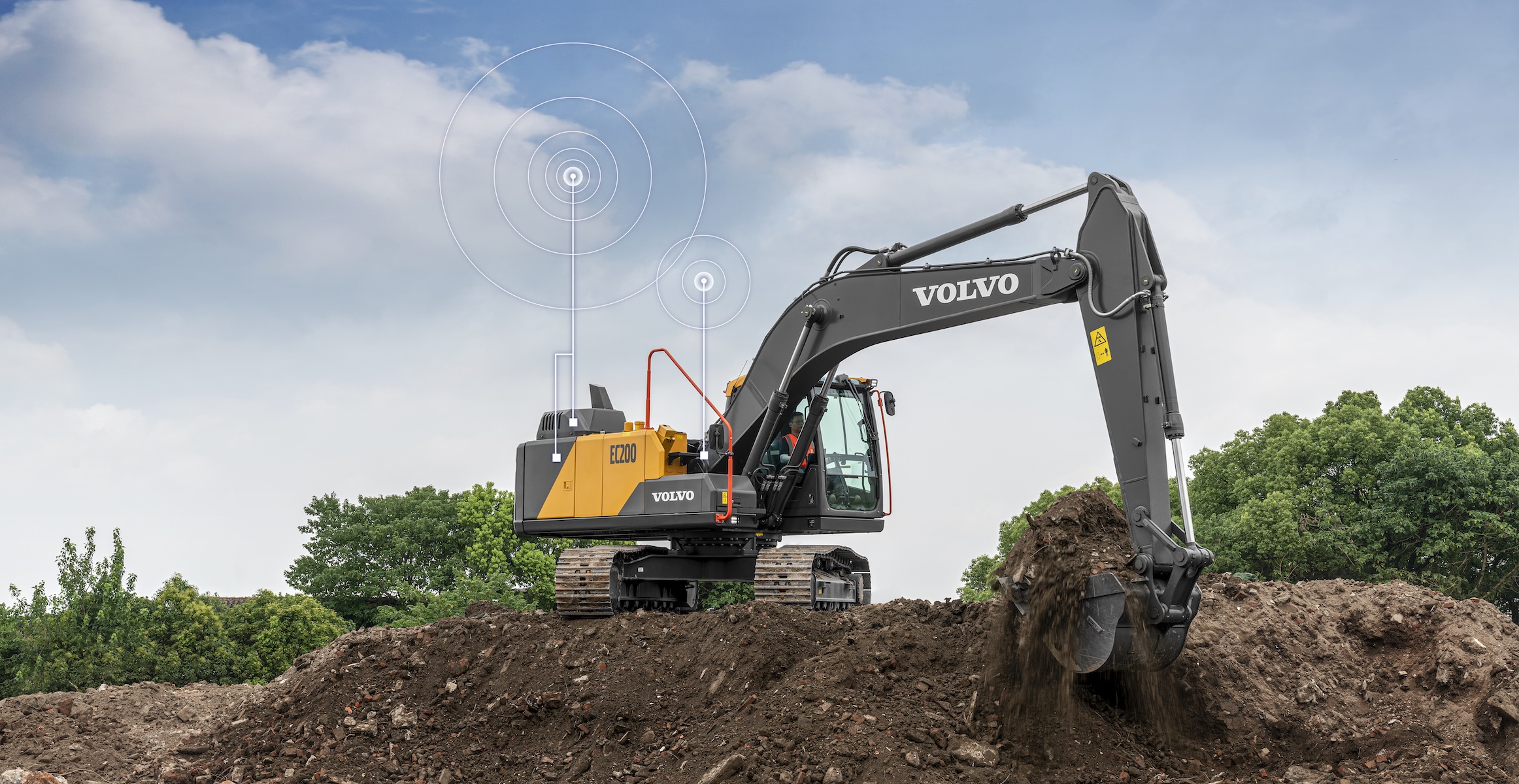 A Volvo EC200 excavator digging dirt with a construction equipment telematics data transfer illustrated above it.