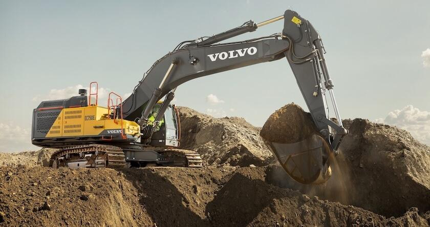 A Volvo EC750E excavator digging dirt in construction.