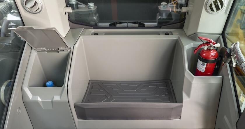The storage compartments inside a new Volvo excavator cabin.