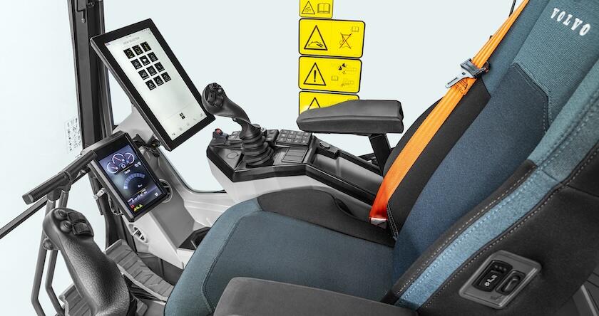 A side view of the inside of an operator cab on a new Volvo excavator.